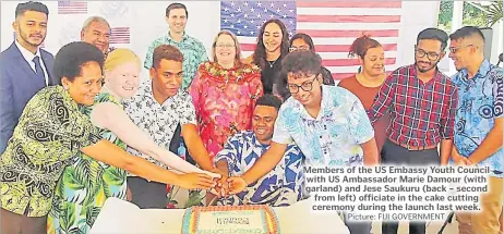  ?? Picture: FIJI GOVERNMENT ?? Members of the US Embassy Youth Council with US Ambassador Marie Damour (with garland) and Jese Saukuru (back – second from left) officiate in the cake cutting ceremony during the launch last week.