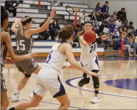  ?? Terrance Armstard/News-Times ?? Finding a teammate: Parkers Chapel's Taylor Fortune makes a pass to T.K. Burson during the Lady Trojans' game against Smackover earlier this season at Parkers Chapel. Tonight, the Lady Trojans take on Fordyce in the opening round of the district tournament needing a victory to keep their season alive.