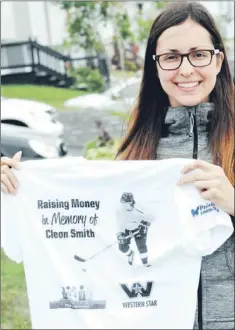  ?? — Photo by Joe Gibbons/the Telegram ?? Trish Smith displays the back of a T-shirt she had made for this Sunday’s Tely 10 Road Race that she is running in memory of her late brother Cleon Smith. Her brother, a hockey player, went missing last year while out walking in a snowstorm.