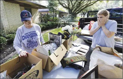  ?? AP PHOTO ?? Judy Mellon, left, is helped by her daughter, Beth Kendrick, as she sorts through items damaged by floodwater­s from Tropical Storm Harvey yesterday in Houston.