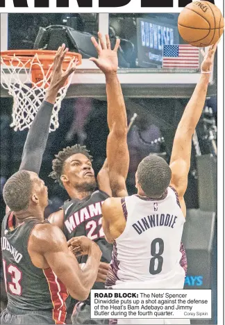  ?? Corey Sipkin ?? ROAD BLOCK: The Nets’ Spencer Dinwiddie puts up a shot against the defense of the Heat’s Bam Adebayo and Jimmy Butler during the fourth quarter.