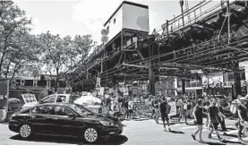  ?? JULIUS CONSTANTIN­E MOTAL/AP ?? Hundreds of marchers opposing the Trump administra­tion’s immigratio­n enforcemen­t plans pass an elevated train station Sunday in the Queens borough of New York.