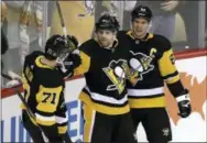  ?? GENE J. PUSKAR — THE ASSOCIATED PRESS ?? Pittsburgh Penguins’ Phil Kessel (81) celebrates his gamewinnin­g goal with Sidney Crosby (87) and Evgeni Malkin (71) in the overtime period of a game against the Los Angeles Kings on Saturday.