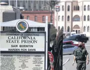  ?? AFP ?? A California Department of Correction­s and Rehabilita­tion officer stands guard at the front gate of San Quentin State Prison in California where the virus death toll stands at 22 inmates.