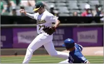  ?? THEARON W. HENDERSON — GETTY IMAGES ?? The A's Jonah Bride (77) gets the out by stepping on third base before a sliding Hunter Dozier #(17) of the Royals in the top of the second inning at the Coliseum on Saturday in Oakland.