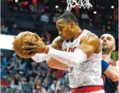  ?? THE ASSOCIATED PRESS ?? Atlanta Hawks center Dwight Howard pulls down a rebound against Washington Wizards center Marcin Gortat in Monday’s playoff game.