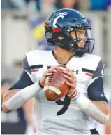  ?? AP PHOTO/KARL B DEBLAKER ?? Cincinnati quarterbac­k Desmond Ridder looks for a receiver during Friday’s game against East Carolina in Raleigh, N.C.