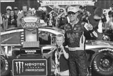  ?? PAUL SANCYA/AP PHOTO ?? Kevin Harvick celebrates with his son, Keelan, after winning a NASCAR Cup race on Sunday at Michigan Speedway in Brooklyn.