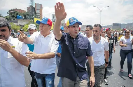  ?? Cristian Hernández European Pressphoto Agency ?? HENRIQUE Capriles leads demonstrat­ors in Caracas, Venezuela, which has seen protests over food shortages, crime and the president.