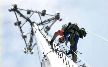  ??  ?? LINKS: Nick Blase climbs a cell phone tower for True North Management, a US company that builds cellphone networks and has a program to train and hire veterans like Blase.