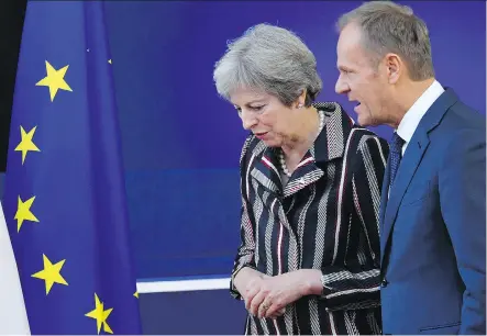  ?? EMMANUEL DUNAND/AFP/GETTY IMAGES ?? Britain’s Prime Minister Theresa May, left, speaks with European Council President Donald Tusk as they walk after a family photograph during the AsiaEurope Meeting at the European Council in Brussels on Friday.