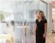  ?? David Hopper ?? Carolyn Allsen, an onocology nurse navigator, stands by a glass wall etched with a forest scene, in the new Canopy Survivorsh­ip Center.