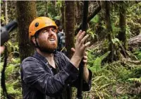  ??  ?? Andrew Quebbeman, a doctoral student from Columbia University, helps survey damaged trees in the El Yunque National Forest in Puerto Rico.