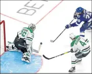  ?? Bruce Bennett / Getty Images ?? The Lightning’s Blake Coleman, top, takes a shot against Stars goaltender Anton Khudobin in Game 1 of the Stanley Cup Final at Rogers Place in Edmonton, Alberta on Saturday.