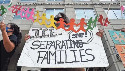  ?? OLIVIER DOULIERY/AFP VIA GETTY IMAGES ?? Protesters gather at Immigratio­n and Customs Enforcemen­t’s HQ in Washington in 2020.