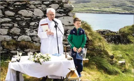  ?? All photos by Michael Donnelly. ?? Altar server Conall Cournane assists Fr Liam O’Brien during the St Crohan’s NS reunion mass on Abbey Island.