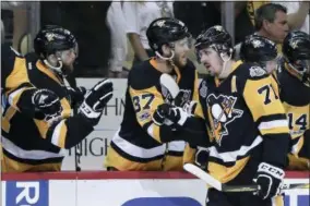  ?? KEITH SRAKOCIC — THE ASSOCIATED PRESS ?? Pittsburgh Penguins’ Carter Rowney (37) celebrates with Evgeni Malkin (71) after he scored against the Nashville Predators during Game 1 of the NHL hockey Stanley Cup Finals, Monday in Pittsburgh.