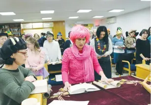  ?? (Gershon Elinson/Flash90) ?? WOMEN READ the Scroll of Esther at a synagogue in Efrat on Saturday evening.