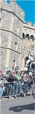  ?? Pictures: PA. ?? Rehearsals for tomorrow’s royal wedding take place in Windsor yesterday, watched by supporters of the royal family.