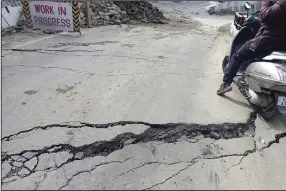  ?? (AP) ?? A motorist navigates his way around a crack in a road on Tuesday in Joshimath, India.