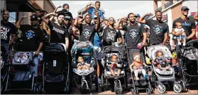  ?? THE DAD GANG ?? A group of fathers who showed up for The Dad Gang’s “Strollin’ with the Homies” event last year in Atlanta to counter the stereotype about absentee Black fathers. “The purpose of the stroll was to visually demonstrat­e the strength of Black fatherhood,” says founder Sean Williams.