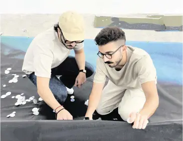  ?? ANTHONY SPINELLO Courtesy of Spinello Projects ?? Elliot and Erick Jiménez work on their ‘Reclining Mermaid’ public artwork ahead of Miami Art Week.