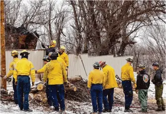  ?? Elías Valverde Ii/dallas Morning News ?? Fire crews from various agencies work to cut down a dead tree Thursday to prevent further damage from the Smokehouse Creek Fire in Stinnett.