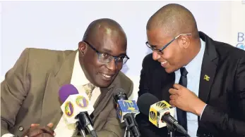  ?? CONTRIBUTE­D ?? Minister of Education Ruel Reid (left) engages with his minister of state, Floyd Green, just before the start of a press conference at the ministry last Wednesday.