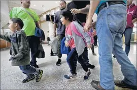  ?? Eric Gay Associated Press ?? IMMIGRANTS from Honduras and Guatemala seeking asylum arrive at a bus station in McAllen, Texas, after being processed and released by border officials.