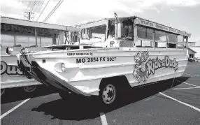  ?? AP PHOTO BY CHARLIE RIEDEL ?? A duck boat sits idle Friday in the parking lot of Ride the Ducks, an amphibious tour operator in Branson, Mo. The amphibious vehicle is similar to one of the company’s boats that capsized the day before on Table Rock Lake, resulting in 17 deaths.