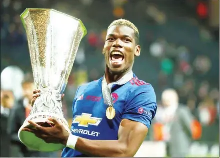  ?? SOREN ANDERSSON/AFP ?? Paul Pogba celebrates with the trophy after Manchester United won the UEFA Europa League final with Ajax at the Friends Arena in Solna outside Stockholm on Wednesday night.