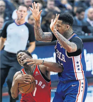  ?? RICK MADONIK TORONTO STAR ?? Philadelph­ia forward Wilson Chandler tries to look innocent after fouling Raptors guard Kyle Lowry in the first half Wednesday. Lowry and the Raptors took down the visiting 76ers 113-102. For more, see the Game Centre on S2.