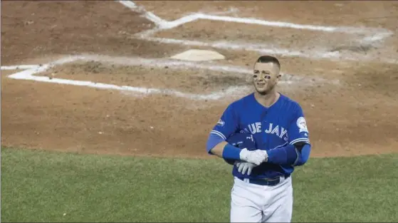  ?? CHRIS YOUNG, THE CANADIAN PRESS ?? Blue Jays shortstop Troy Tulowitzki walks back to the dug out after fouling out to Cleveland Indians pitcher Cody Allen to end Game 5 — and to finish the season for the ALDS winners.