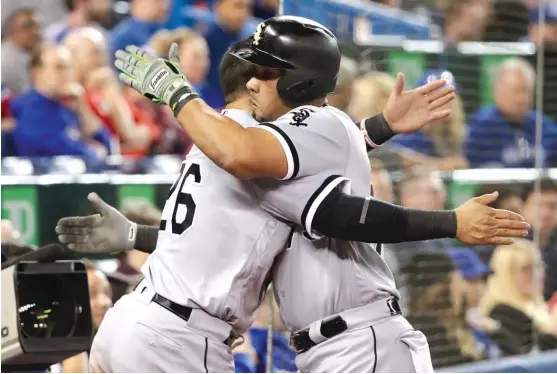  ?? TOM SZCZERBOWS­KI/ GETTY IMAGES ?? Avisail Garcia ( left) congratula­tes Jose Abreu after Abreu’s solo home run in the eighth inning off Ryan Tepera broke a 3- 3 deadlock.