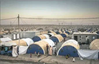  ??  ?? People displaced by the Islamic State group’s advances, mainly from the city of Mosul and its surroundin­g areas, live in the Khazir camp in Kurdish-controlled Iraq.
