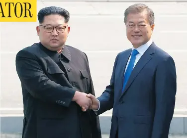  ?? KOREA BROADCASTI­NG SYSTEM VIA AP ?? North Korean leader Kim Jong Un, left, shakes hands with South Korean President Moon Jae-in at the border of the two countries Friday, before crossing into South Korea for historic face-to-face talks in Panmunjom.