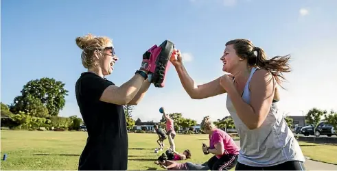  ?? BRADEN FASTIER/ THE LEADER ?? Edee Harris, left, works to take out obstacles that stop people from exercising.