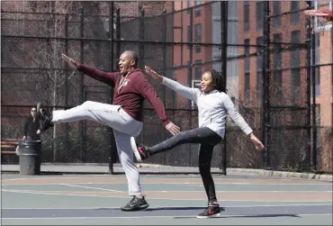  ?? KATHY WILLENS - ASSOCIATED PRESS ?? Fred Frazer, a property manager, exercises with his daughter Olivia, 10, on the Christophe­r “Biggie” Wallace basketball courts in Brooklyn in this Thursday, March 26, 2020, file photo. During the pandemic, people around the world sought relief from lockdowns and working from home in leisure sports.