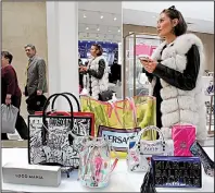  ?? AP/MARK LENNIHAN ?? A woman shops at Neiman Marcus during the opening night of The Shops & Restaurant­s at Hudson Yards in New York in March.