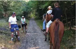  ?? Local Motion ?? BELOW:
Cyclists meet horseback riders on the Hop River State Park Trail in Connecticu­t.