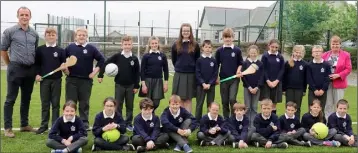 ??  ?? Tombrack National School boys and girls pictured at their new astro turf pitch with teacher Bobby Kenny and principal Alice Doyle.