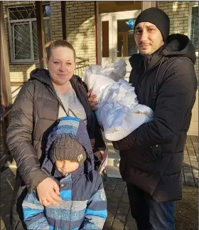  ?? (AP/Olena Lykhovyd) ?? Anastasiia Havryshenk­o poses Feb. 26, 2022, with her family including young son Artem, who was born on Feb. 24, 2022, in front of the maternity center in Sumy, Ukraine.