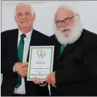  ??  ?? FAI President Tony Fitzgerald presenting a laque on behalf of the FAI to Kanturk AFC chairman Michael O’Driscoll.