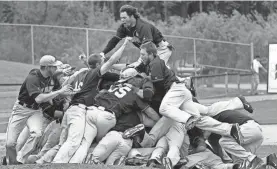  ?? MARK HOFFMAN/MILWAUKEE JOURNAL SENTINEL ?? The UW-Whitewater baseball team celebrates its 2014 NCAA Division III championsh­ip.