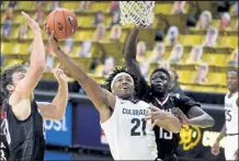  ?? Cliff Grassmick / Boulder Daily Camera ?? Colorado's Evan Battey drives past Omaha's Wanjang Tut. The Colorado Buffaloes played the Nebraska-omaha Mavericks in Boulder on Dec. 16.