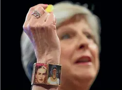  ?? PHOTO: REUTERS ?? Britain’s Prime Minister Theresa May wears a Frida Kahlo bracelet and holds a sweet passed to her as she addresses the Conservati­ve Party conference in a disastrous speech in Manchester. It was odd for for a Conservati­ve prime minister to wear the...