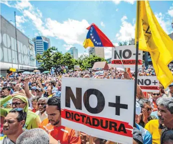  ?? FOTO: AFP ?? Tausende Menschen haben am Samstag in Caracas gegen die Regierung Nicolás Maduros demonstrie­rt. Nach scharfem internatio­nalen Protest ist die Entmachtun­g des Parlaments zurückgeno­mmen worden.