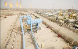  ??  ?? A picture taken on Jan 22, shows a view of installati­ons at the Nahr Bin Omar natural gas field, with flames rising from the burning of excess hydrocarbo­ns seen in the background. Iraq will is expected to sign a memorandum of understand­ing with US...