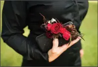  ??  ?? Model Stacy Heath’s handbag is adorned with a floral spray.