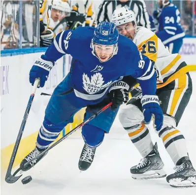  ?? RICK MADONIK TORONTO STAR ?? The Penguins’ Jason Zucker was called for a trip on the Leafs’ Michael Bunting.